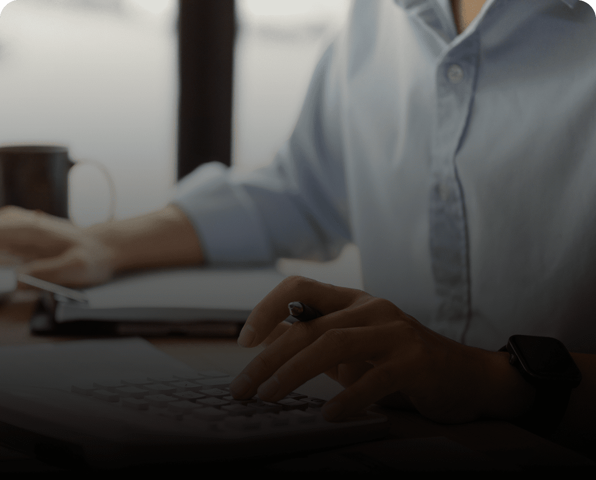 Person typing on a calculator, working.